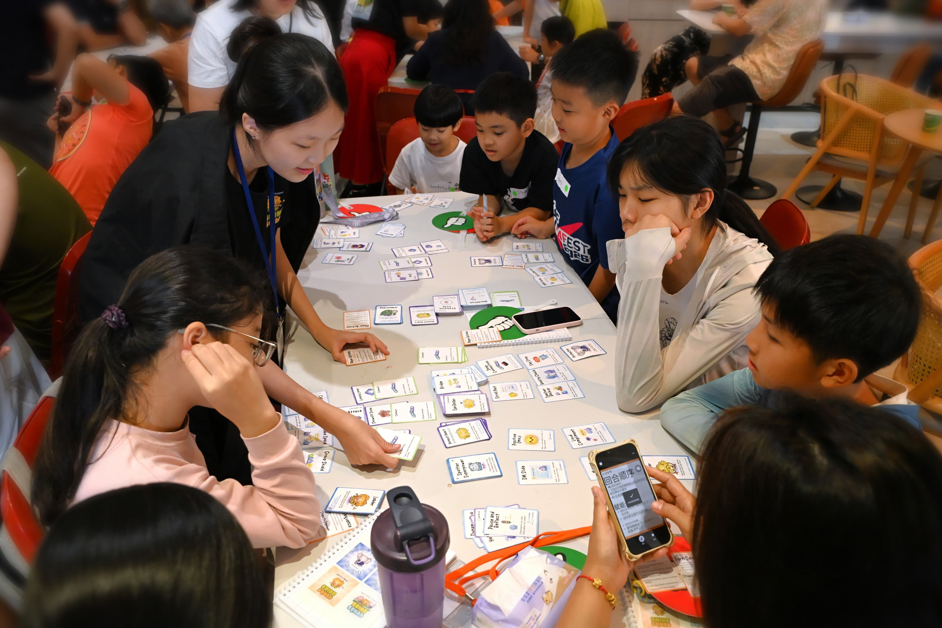 Kids playing the Shine Squad card game, with the background softly blurred to keep the players in focus